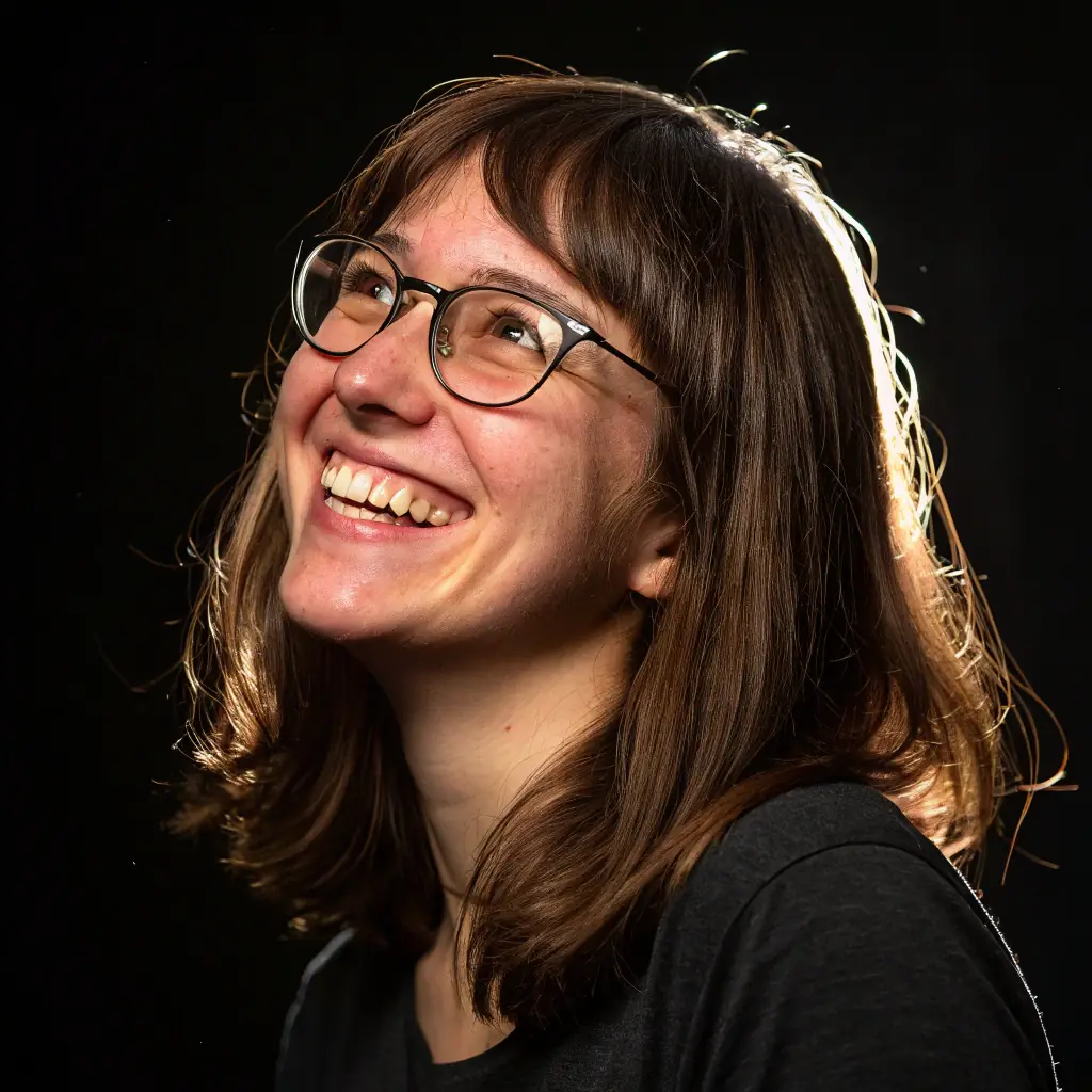 A professional headshot of Ros, the counselor, smiling warmly and looking directly at the camera. She has a kind and approachable demeanor.